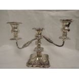 A silver two branch candelabrum of squat form having three removable candle sconces, moulded and