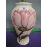 A Moorcroft table lamp of baluster form having magnolia pattern on cream ground