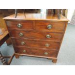 A 19th century chest of drawers having 2 short and 3 long cockbeaded drawers on shaped feet