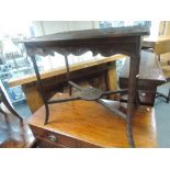 A 19th century stained frame occasional table having extensive carved decoration on slender legs