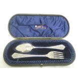 A cased Victorian silver spoon and fork set having extensive engraved decoration to front and