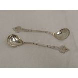 A pair of white metal spoons, possibly Danish having bright cut engraving to decorative terminals