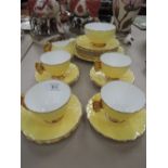 An Aynsley part tea service having yellow butterfly handles on cabbage design yellow ground, Reg