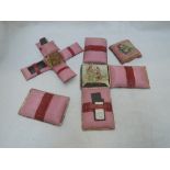 An early 20th Century pink silk and pictorial sewing kit (AF)