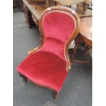 A Victorian mahogany frame spoon back chair having 20th century burgundy dralon upholstery and knurl