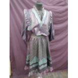 A lady's 1980's dress by Diane Freis in shades of purple and teal having elasticated waist, frill