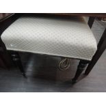A 19th century stained ebonized frame stool having later cream upholstered top