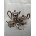A four piece matched silver tea set of plain form having shaped rims with moulded bar and bead