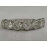 A lady's 7 stone diamond eternity ring, approx 1.75ct in raised claw setting on an 18ct white gold