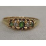 An Edwardian lady's dress ring having diamond and green stones, possibly garnets in a claw set