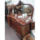 A mid Victorian mahogany chiffonier of large size having foliate crest mirror back with recess