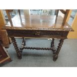 A late Victorian oak side table having lunette carved rim with lion mask handle frieze drawer on