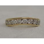 A lady's half eternity ring having nine channel set brilliant cut diamonds, approx .45ct in a shaped
