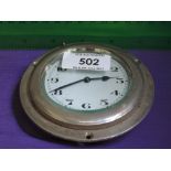 A vintage car clock mounted in chrome bezel