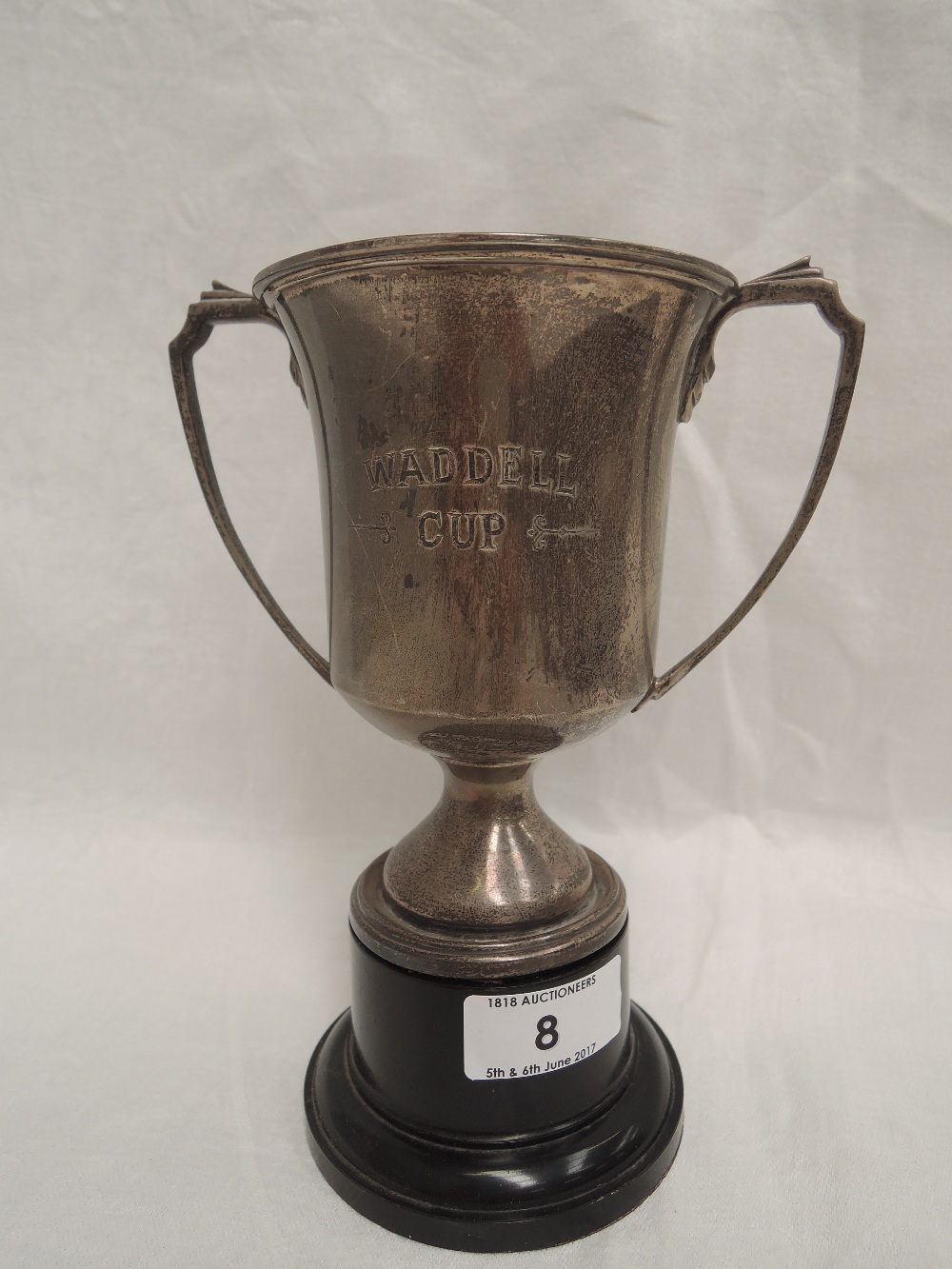 A silver trophy of plain form monogrammed WADDELL CUP, having moulded architectural handles,