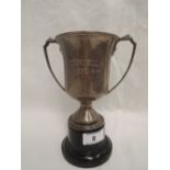 A silver trophy of plain form monogrammed WADDELL CUP, having moulded architectural handles,