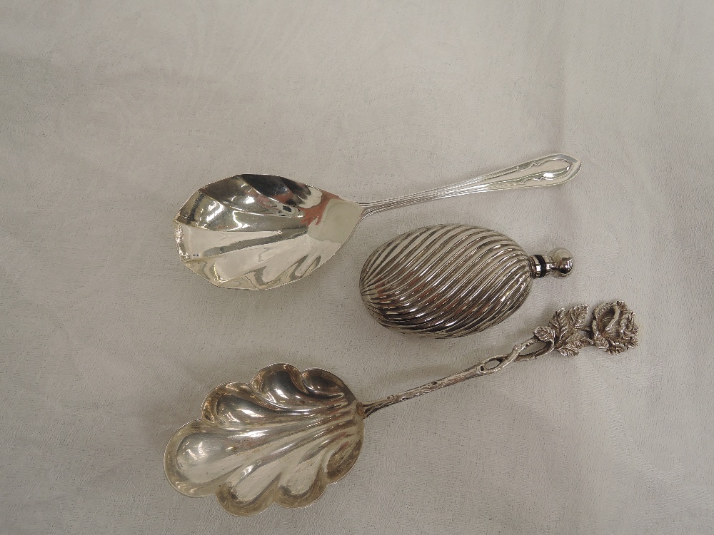 An HM silver jam spoon, white metal jam spoon with moulded handle and a small oval white metal