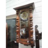 An early 20th century mahogany Vienna wall clock of traditional design having crest, pillar and