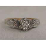 A lady's diamond solitaire dress ring, approx .125ct in a claw setting to shaped white metal