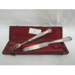 A cased Georgian silver handled child's knife and fork having moulded handles with scallop