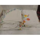 A selection of table linen including embroidered table cloths and tray cloths