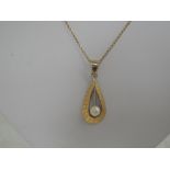 A yellow metal and cultured pearl pendant of teardrop form, stamped 585 and bearing continental