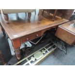 A 19th century mahogany library desk having four frieze drawers with kneehole and turned legs