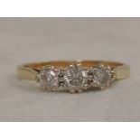 A ladies dress ring having three graduated diamonds, approx .5ct in a raised claw mount on an 18ct