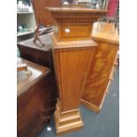 A reproduction Edwardian style satinwood pedestal having square top with dentil cornice and