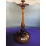 An early/mid 20th century mahogany table lamp having turned column with later shade