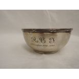A silver christening bowl of plain form having reed and cross moulded rim and inscription to