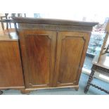 A late Victorian mahogany bookcase having Adam's style frieze decoration with panelled doors on