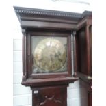 An 18th century stained frame longcase clock having square pillar hood containing brass face and