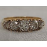 A lady's dress ring having five old cut graduated diamonds with diamond chip decoration, approx 1.