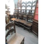 A set of ten late 20th century craftsman made oak dining chairs of Yorkshire design having scroll