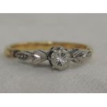 A lady's diamond solitaire dress ring, approx .125ct in a claw setting to shaped white metal