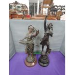 A 19th century spelter figure modelled as lady with volumn and a similar spelter figure modelled