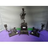 An early 20th century Spelter candle garniture figure group modelled as stork, goats and putti on