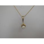 A yellow metal and cultured pearl pendant bearing continental hallmarks, on a 9ct gold fancy link