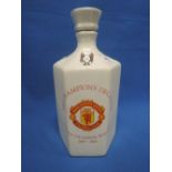 A ceramic bottle of Manchester United The Champions decanter whisky, the treble champions 1998-99