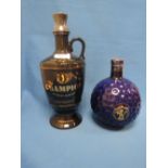 A St Andrews 21 year old whisky The Champion in black ceramic claret jug by Wade, plus a Wade blue