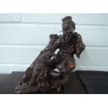 A wood carved oriental figure, fisherman and catch
