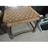 A vintage seagrass seated oak stool