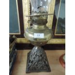 A brass oil lamp on a cast base