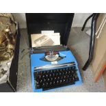 A Silver-Reed typewriter, blue, in case with instructions