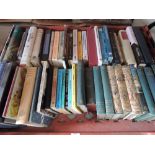 A tray of volumes including Arthur Ransome novels, and reference books