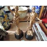 A pair of cast bronzed figures mounted on treen plinths