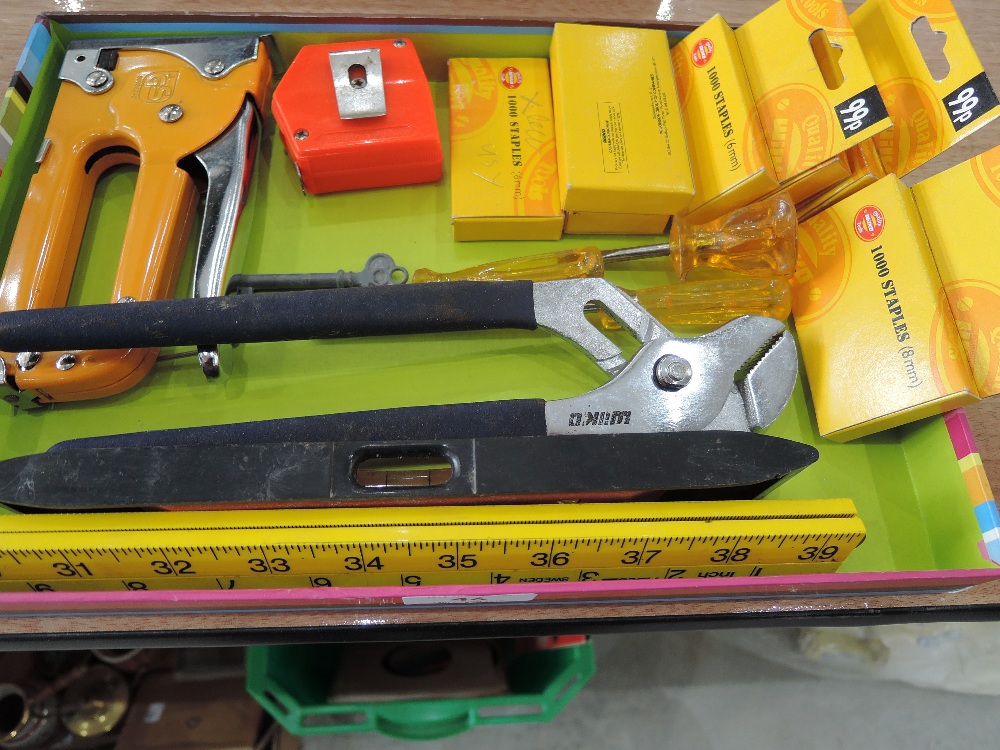 A selection of staples, folding rule, spirit level etc