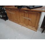 A pine kitchen dresser base having tiled top