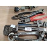 A selection of vintage tools including pipe cutter, pliers and adjustable wrenches